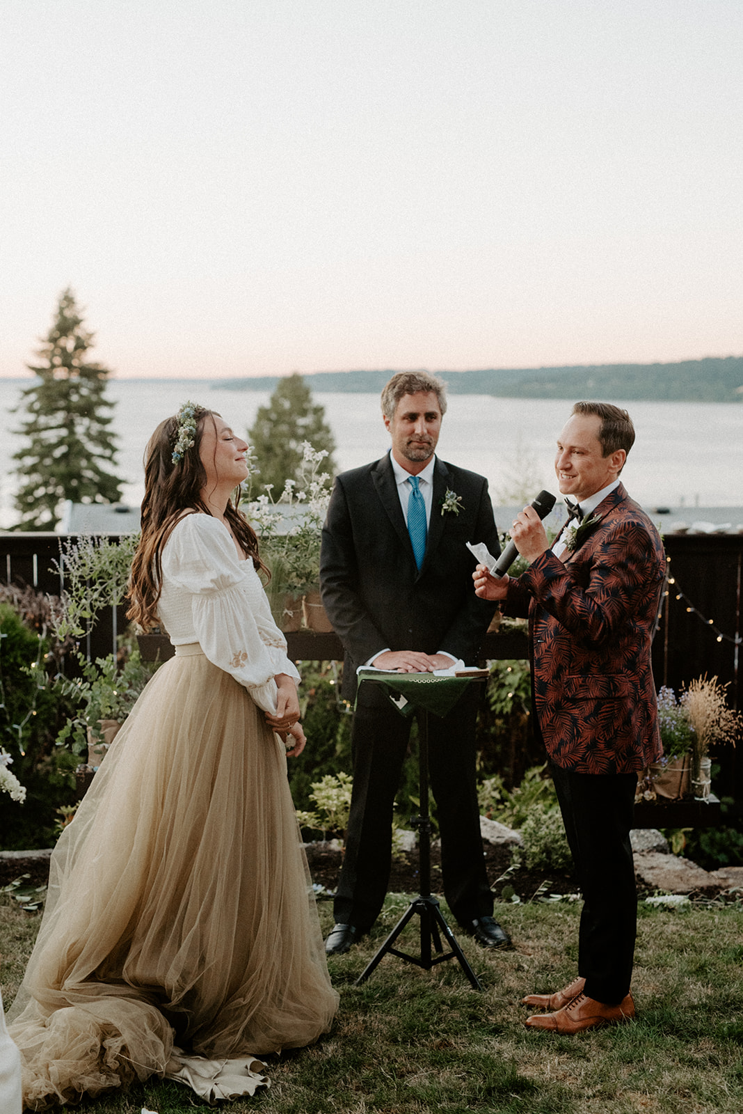 Couple exchanging vows during an outdoor waterfront wedding ceremony