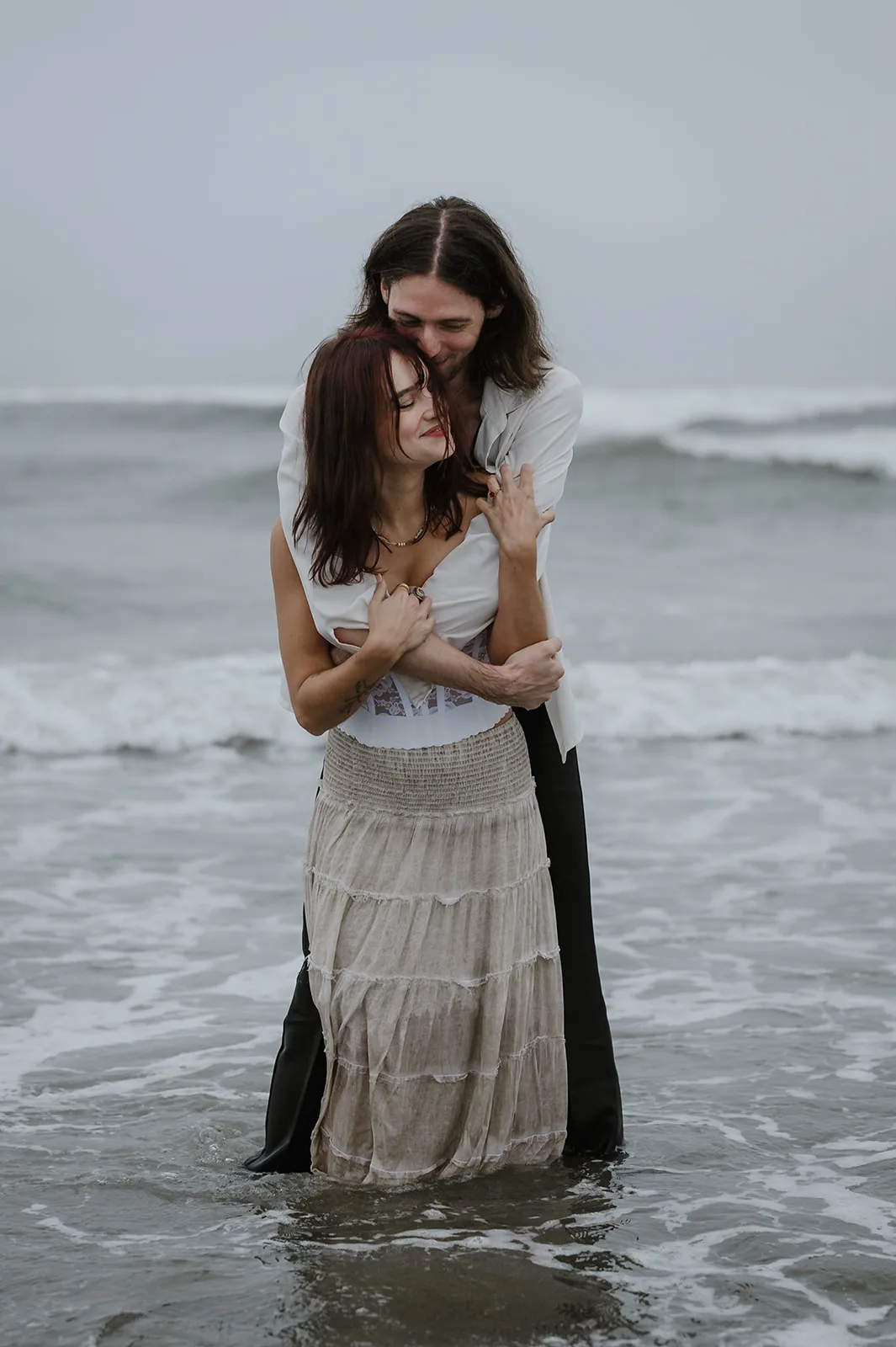 Embrace by the Ocean - Tender Moments on the Oregon Coast Engaged couple in a tender embrace by the ocean on the Oregon coast