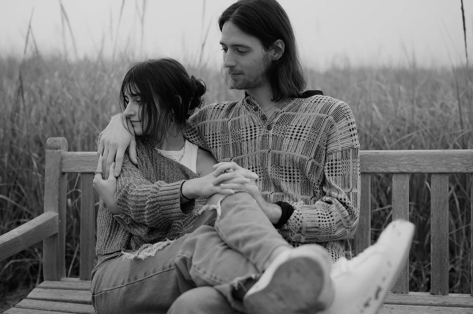 Intimate Moments Captured - Oregon Coast Engagement Photos Intimate black and white engagement portrait on a wooden bench, Oregon coast