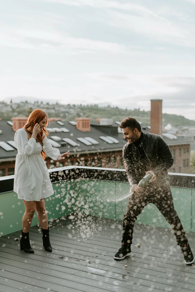 happy wedding couple, mean doing champagne shower both laughing