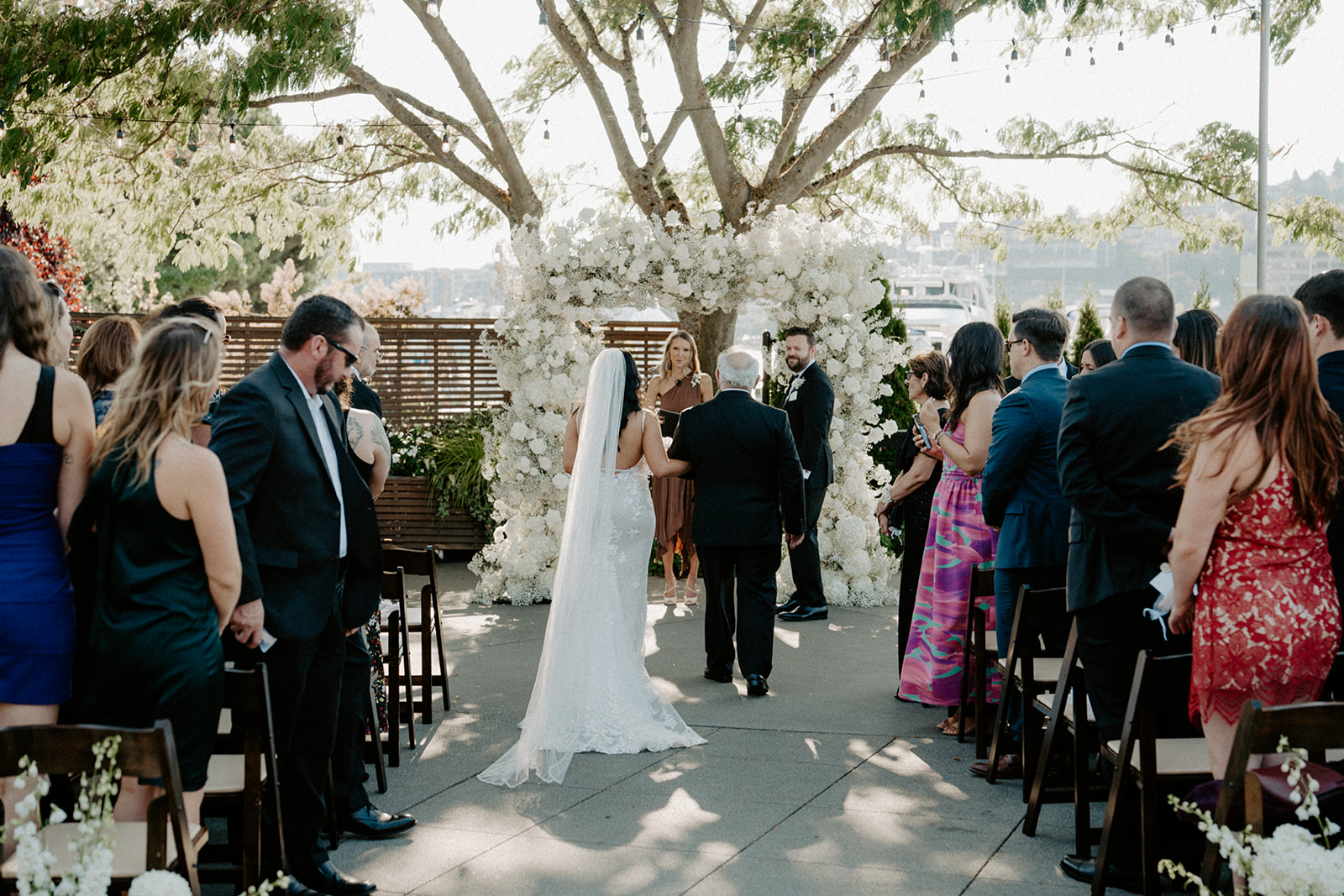 Bride walking down the aisle with her stepfather at a Dockside at Duke’s wedding ceremony.
