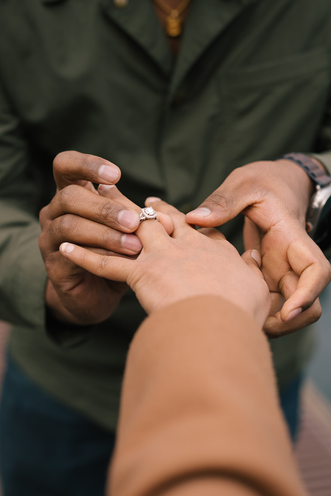 Sudesh sliding the engagement ring onto Madhu’s finger on the dock at Lake Crescent.