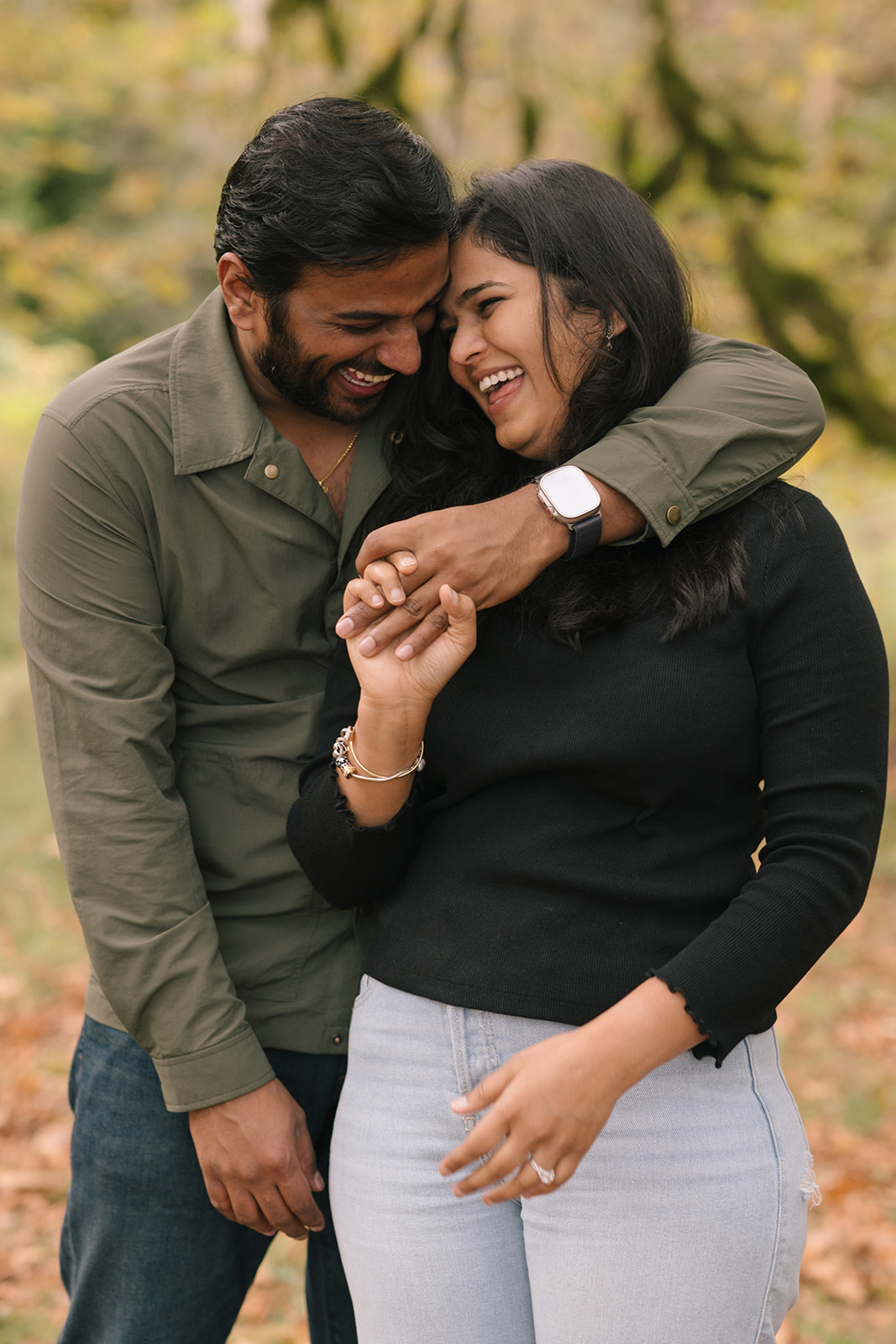 Madhu and Sudesh laughing together while showing off her engagement ring.
