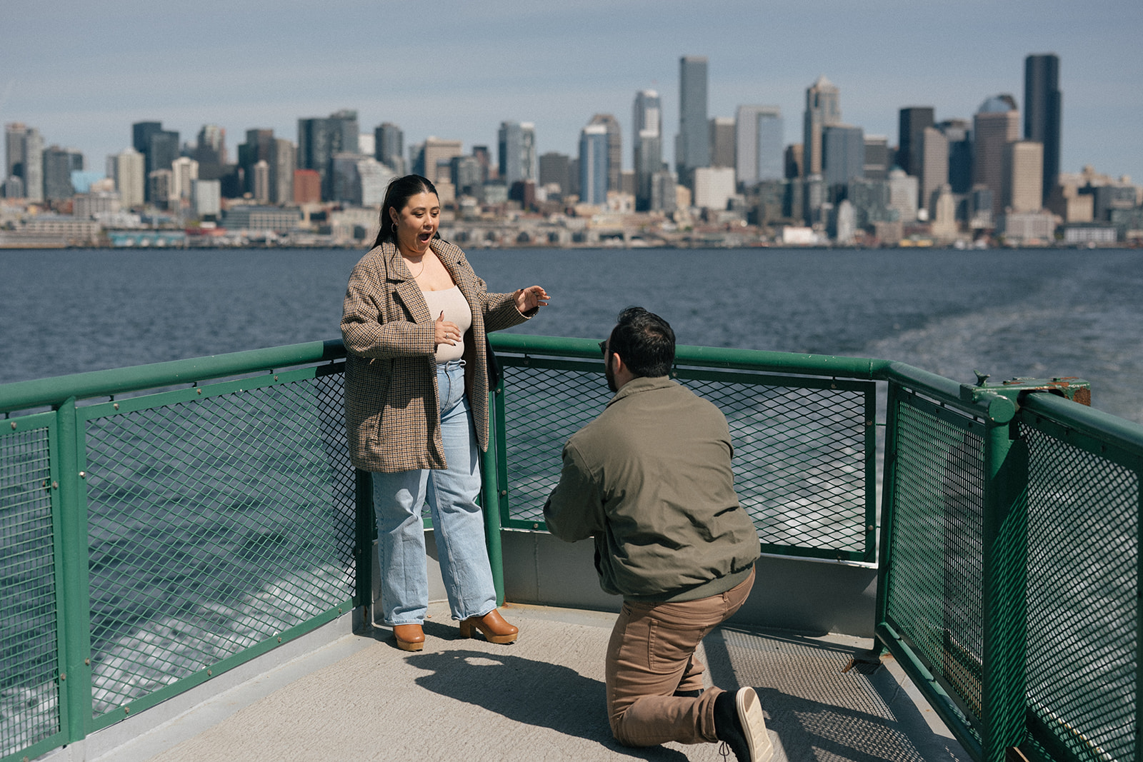 Johnny kneels as Alyssa reacts in shock during the start of the proposal