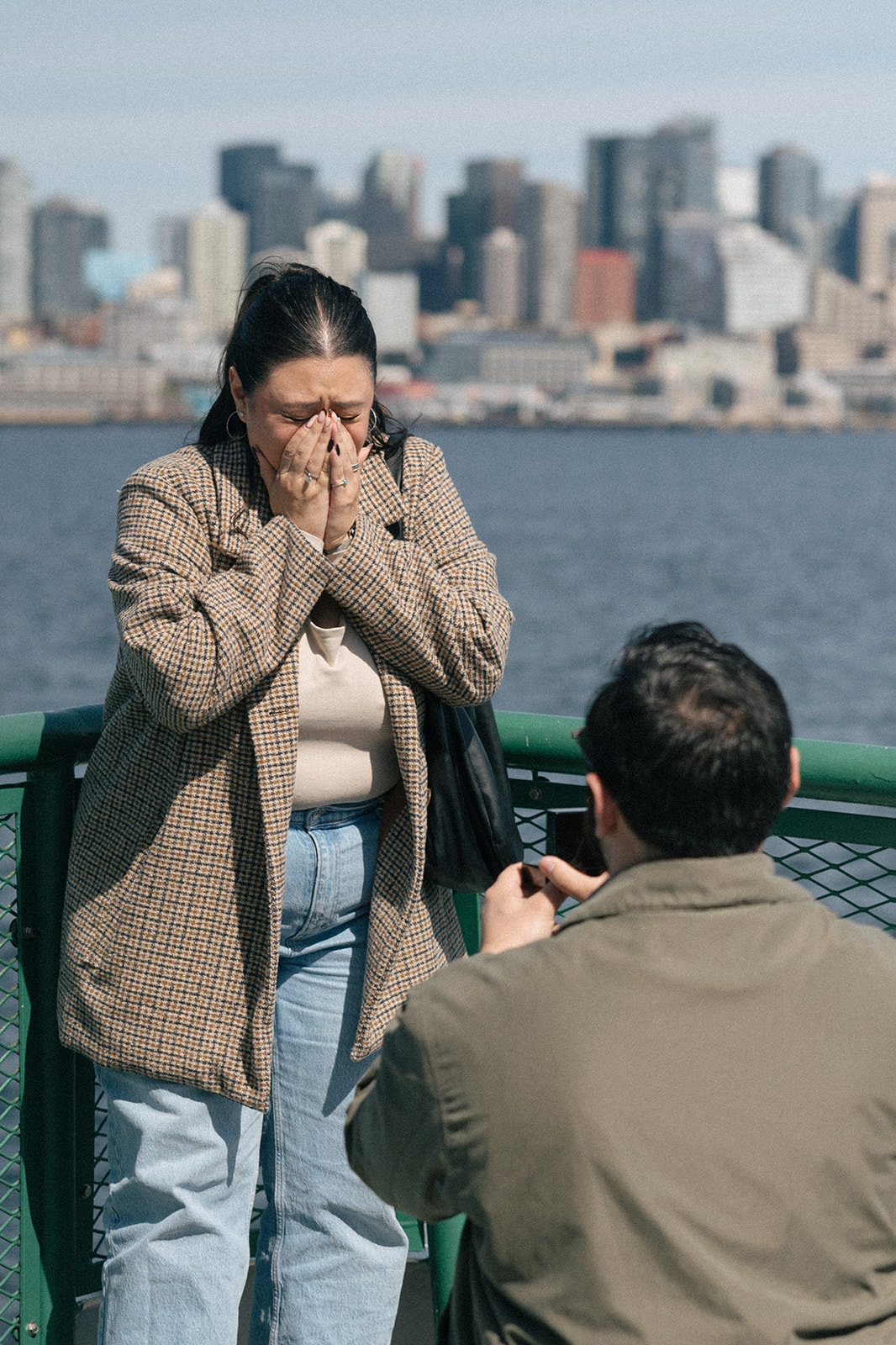 Alyssa covers her face in disbelief as Johnny holds out the ring