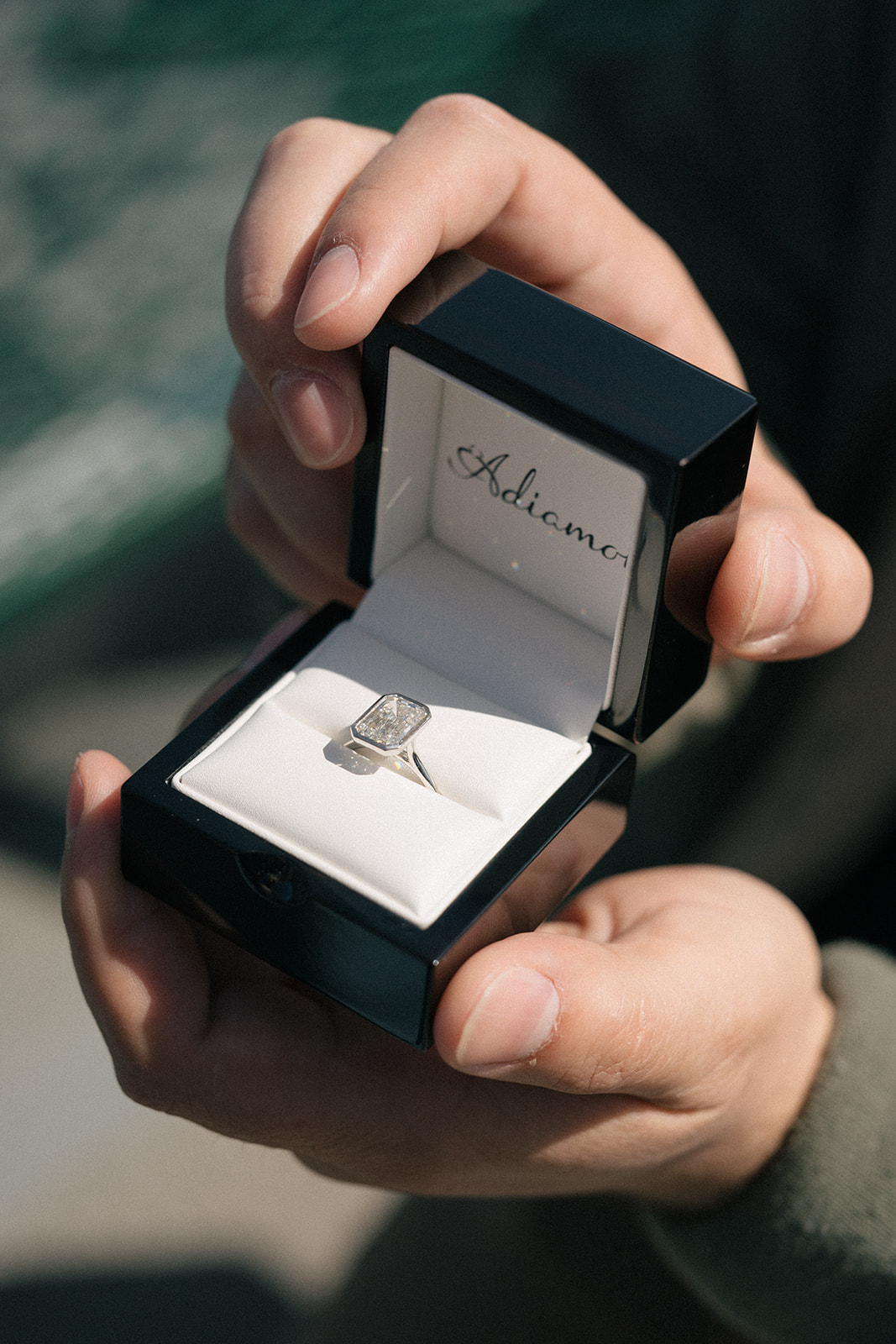 Close-up of rectangular diamond ring in an Adiamo box