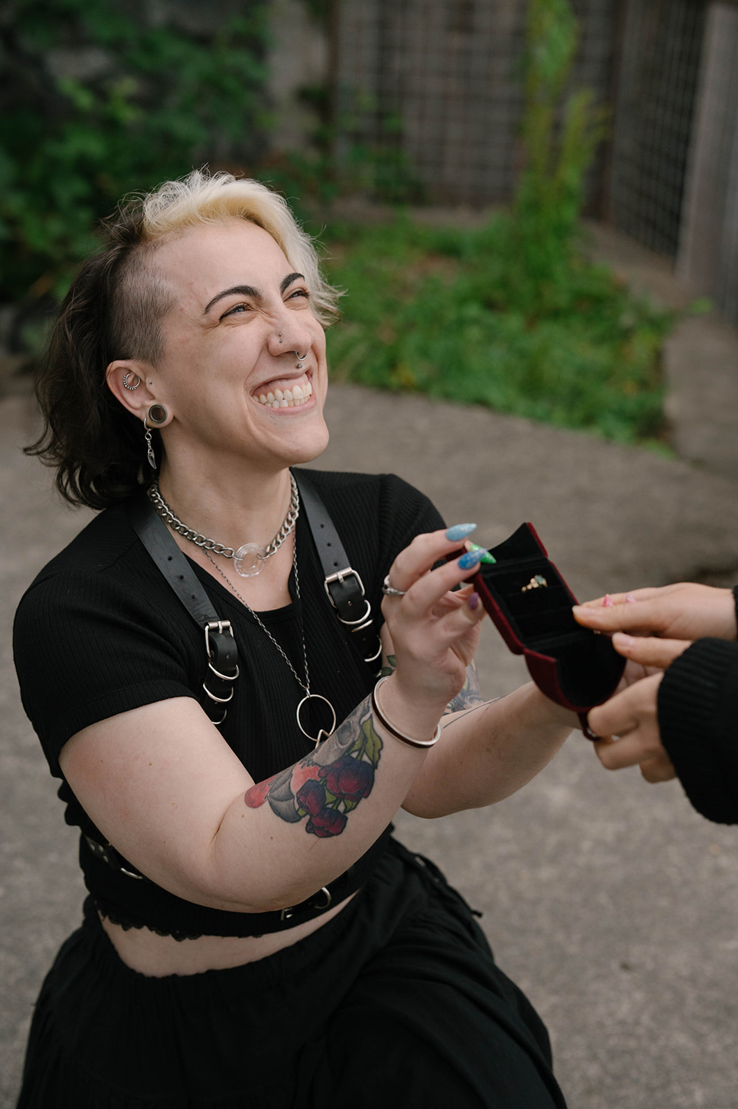 A close-up of a woman smiling while holding an open ring box during a proposal on Whidbey Island.