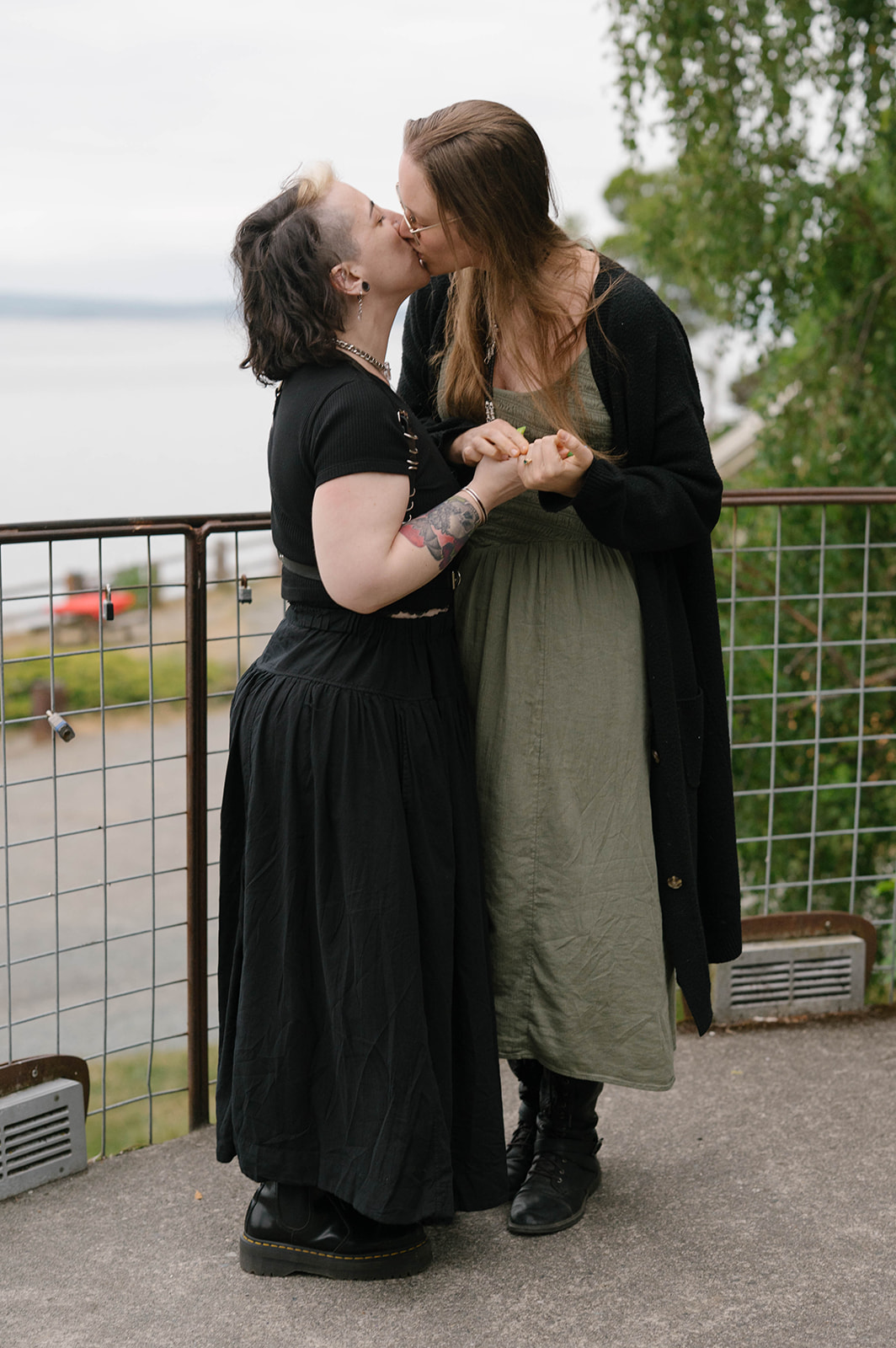 The couple shares another kiss at the railing of a Whidbey Island overlook after their surprise engagement.