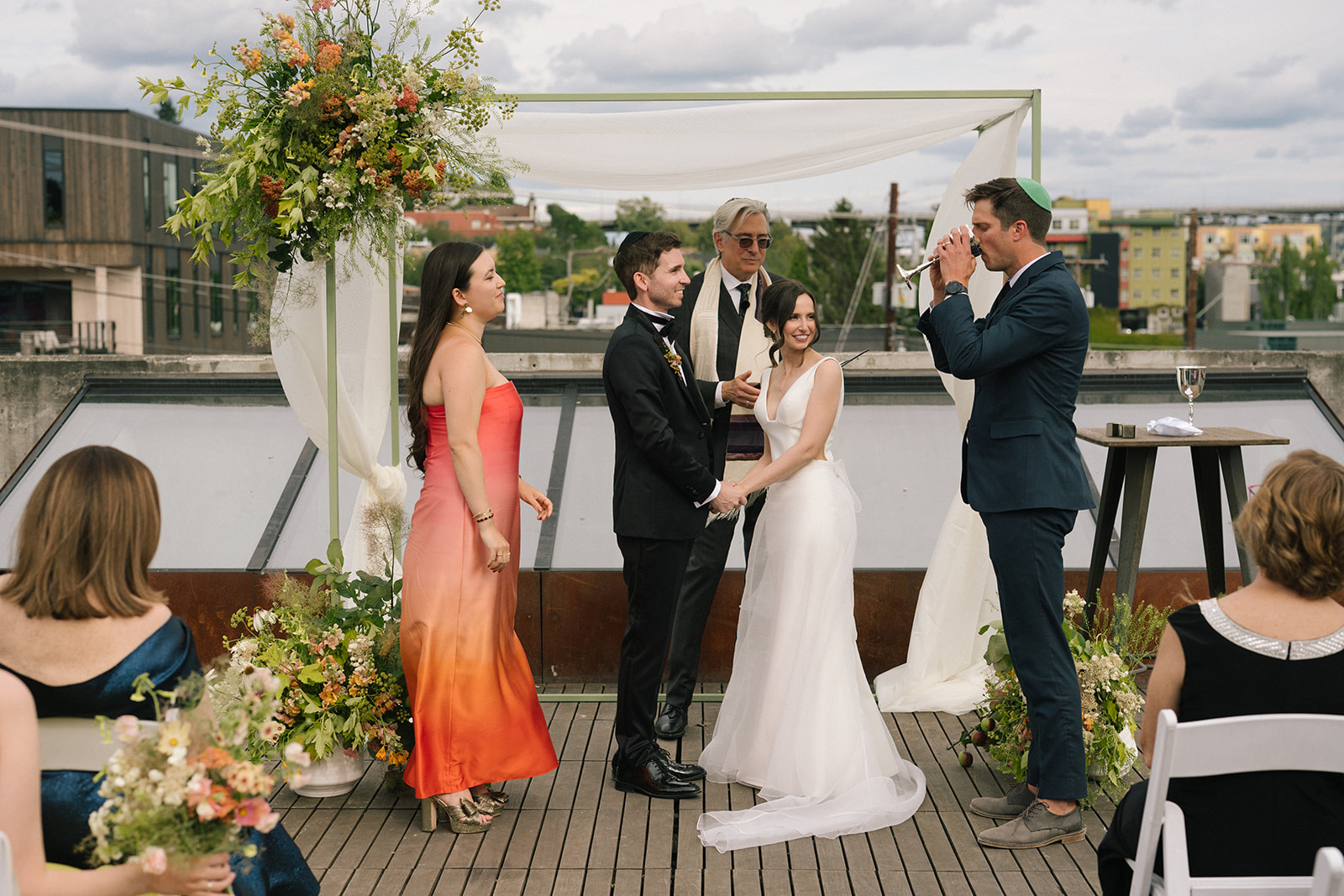 Bride and groom exchanging rings during their rooftop ceremony at the Fremont Foundry in Seattle