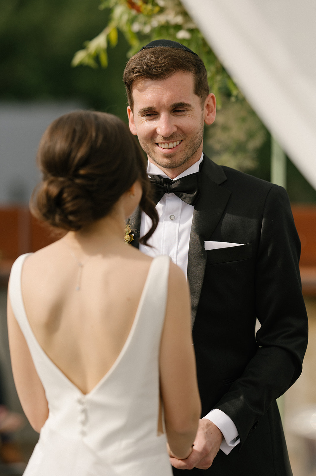 Groom smiling as he sees his bride during their rooftop ceremony at the Fremont Foundry in Seattle