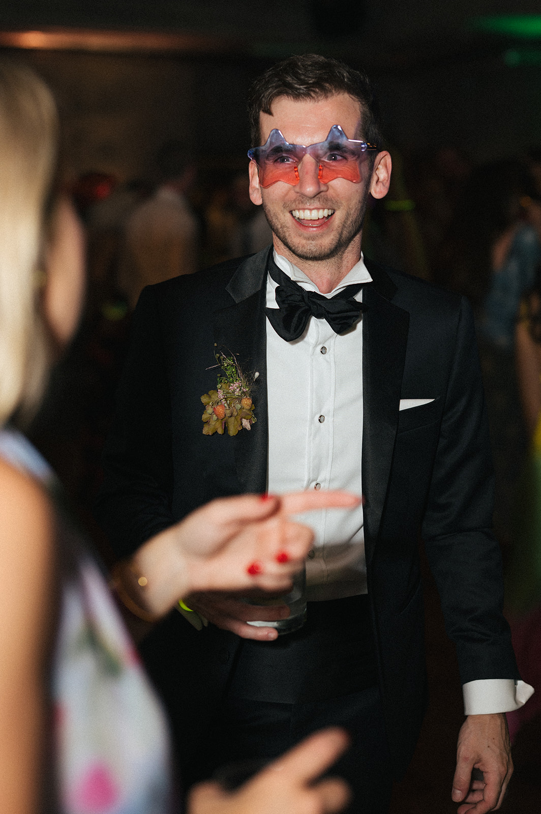 Groom wearing novelty glasses and smiling while dancing at the Fremont Foundry wedding reception