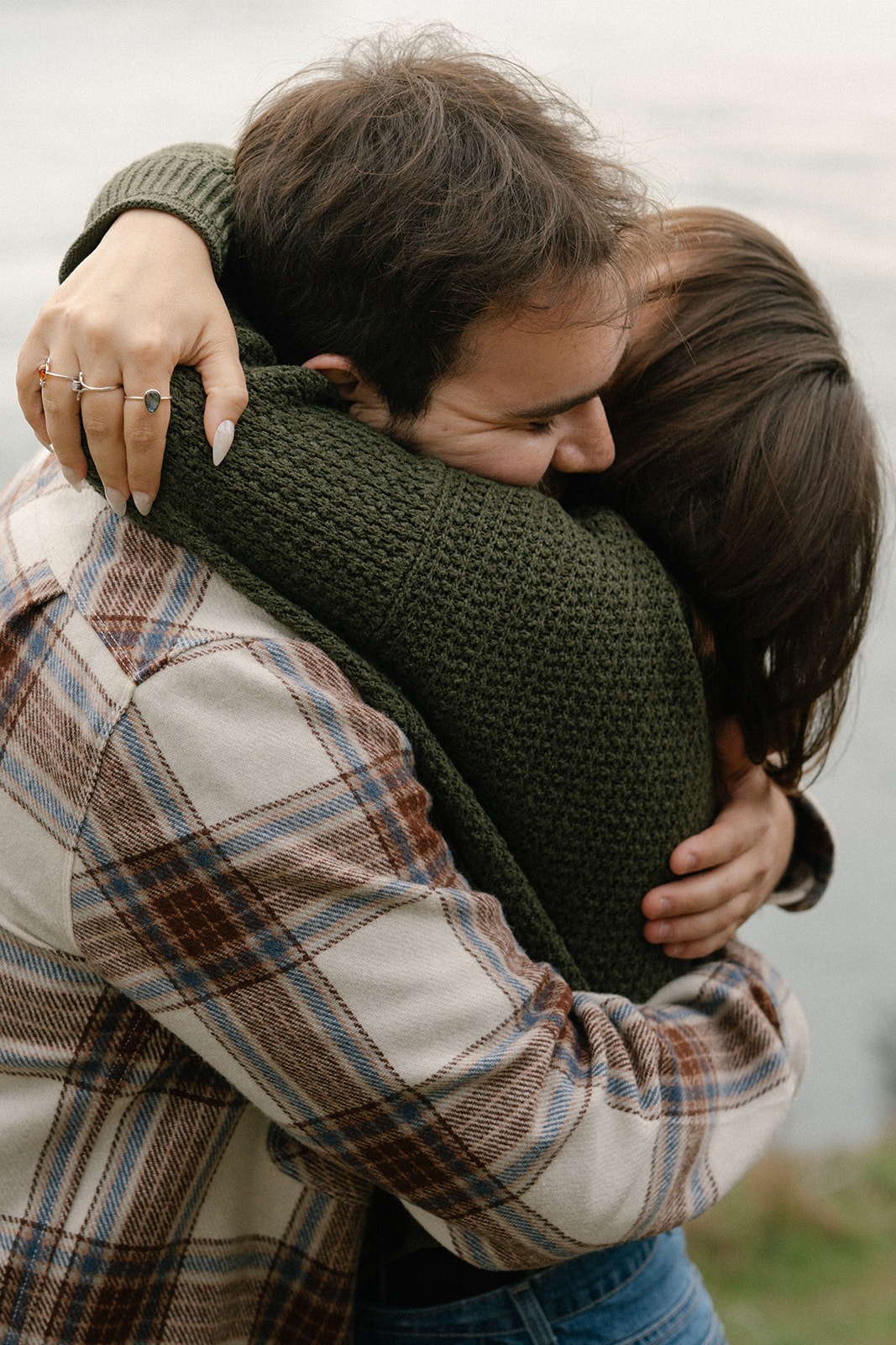 Jonathan and Ashley hug tightly after getting engaged on the cliffside.