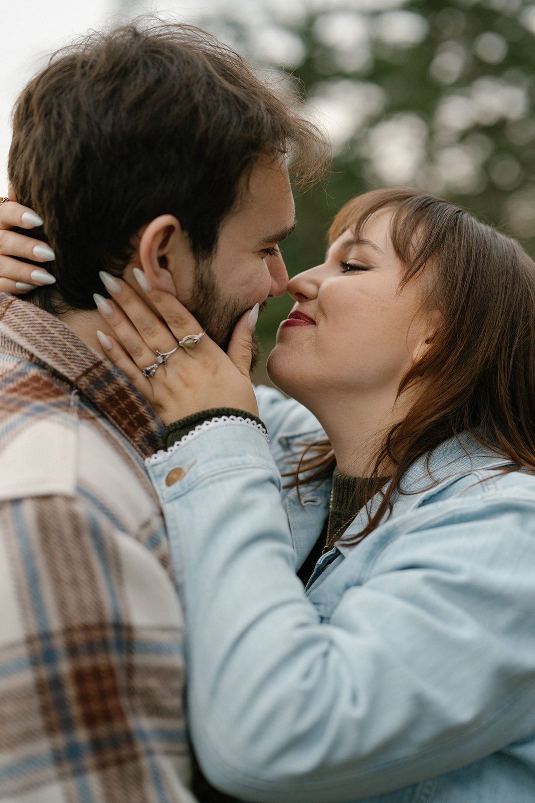 Jonathan and Ashley stand close together, sharing an intimate moment after their proposal at Deception Pass.