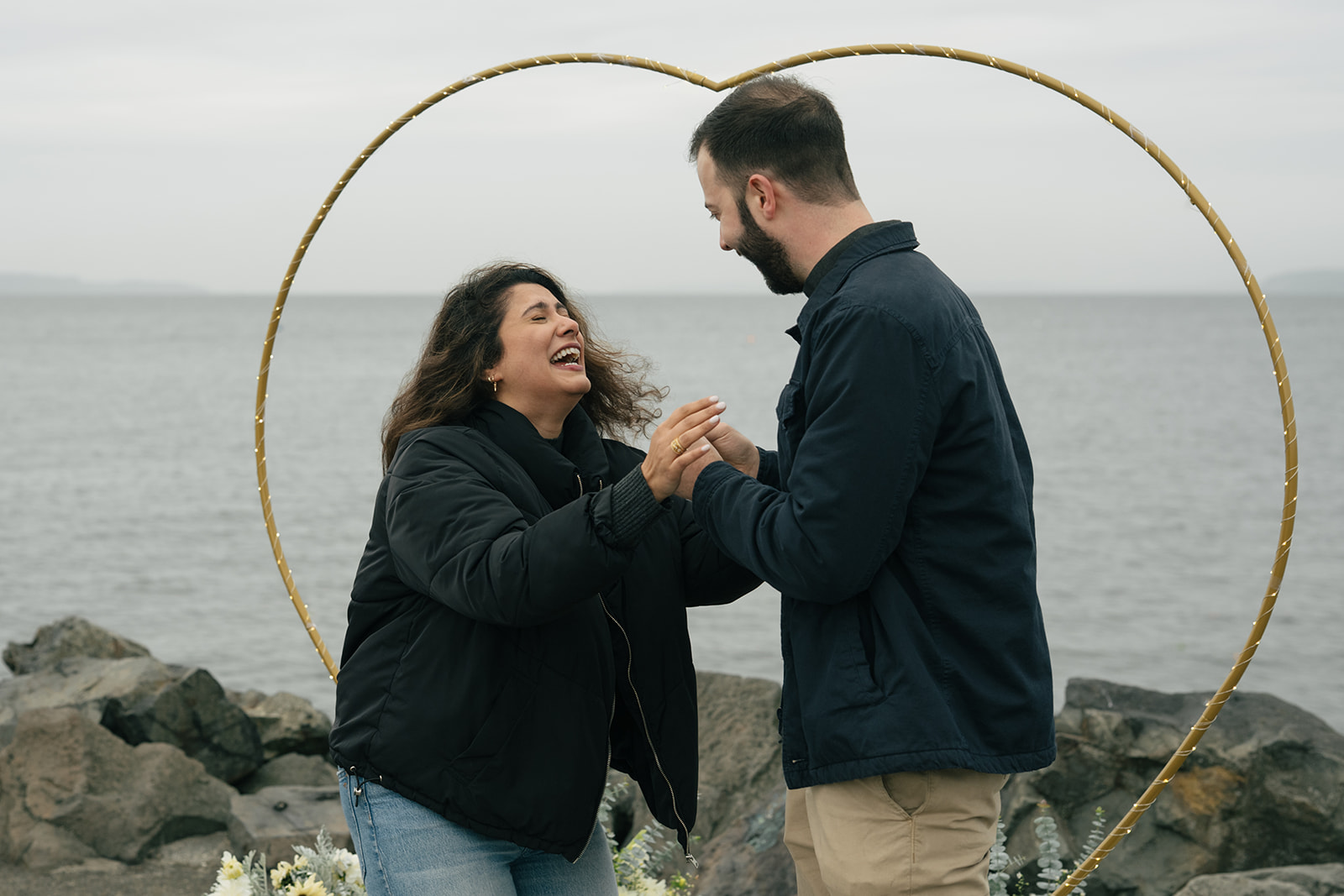 Aysha jumps in excitement as Brad stands in front of her after the proposal.
