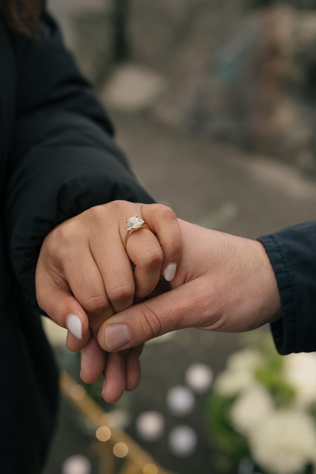 Close-up of Aysha’s engagement ring as she and Brad hold hands after the proposal.