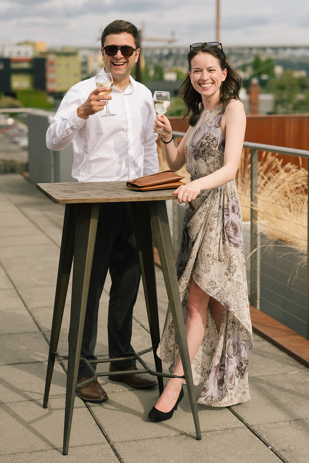Wedding guests standing at a high-top table with drinks during cocktail hour at the Fremont Foundry