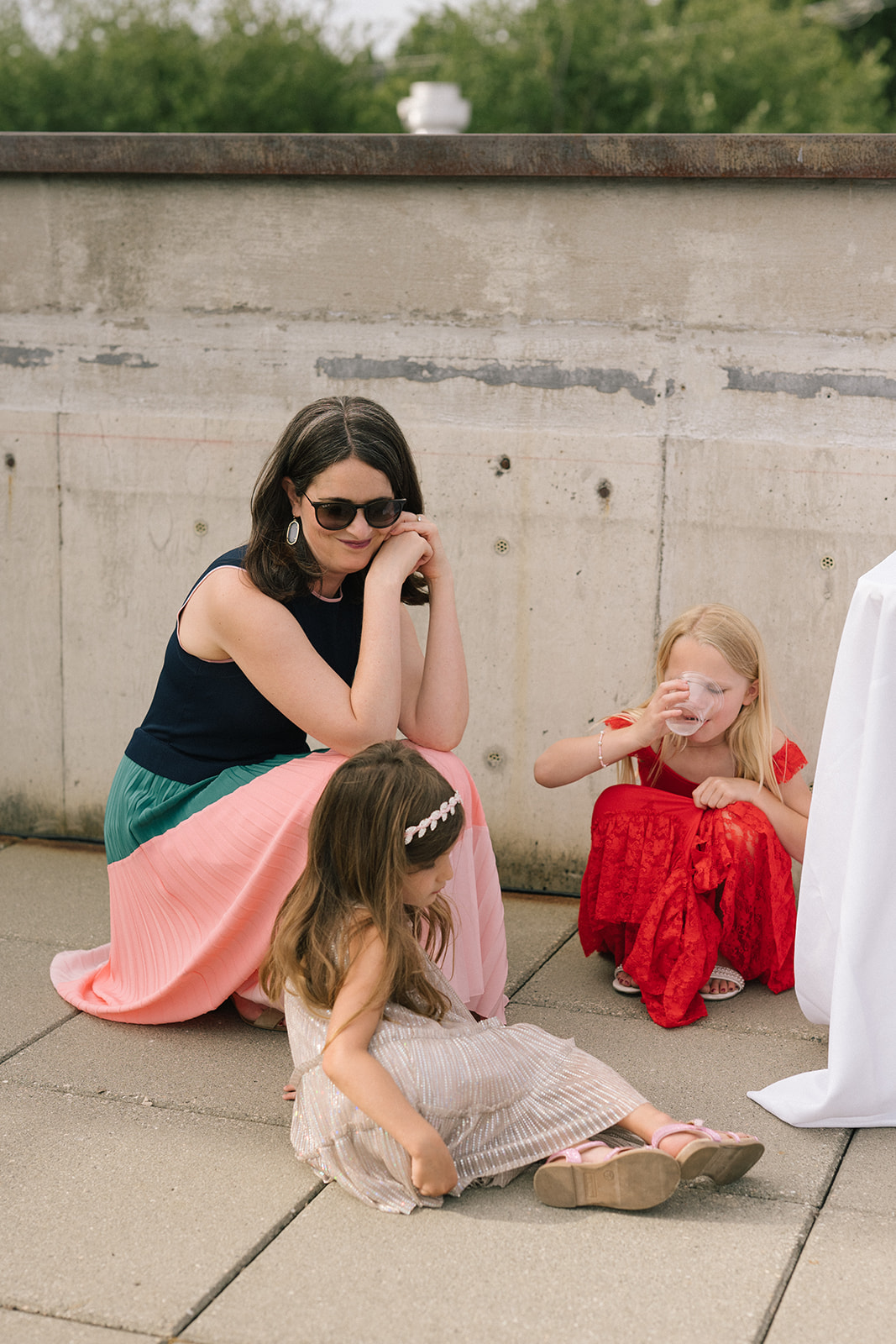 Guest sitting with children during cocktail hour on the Fremont Foundry rooftop in Seattle