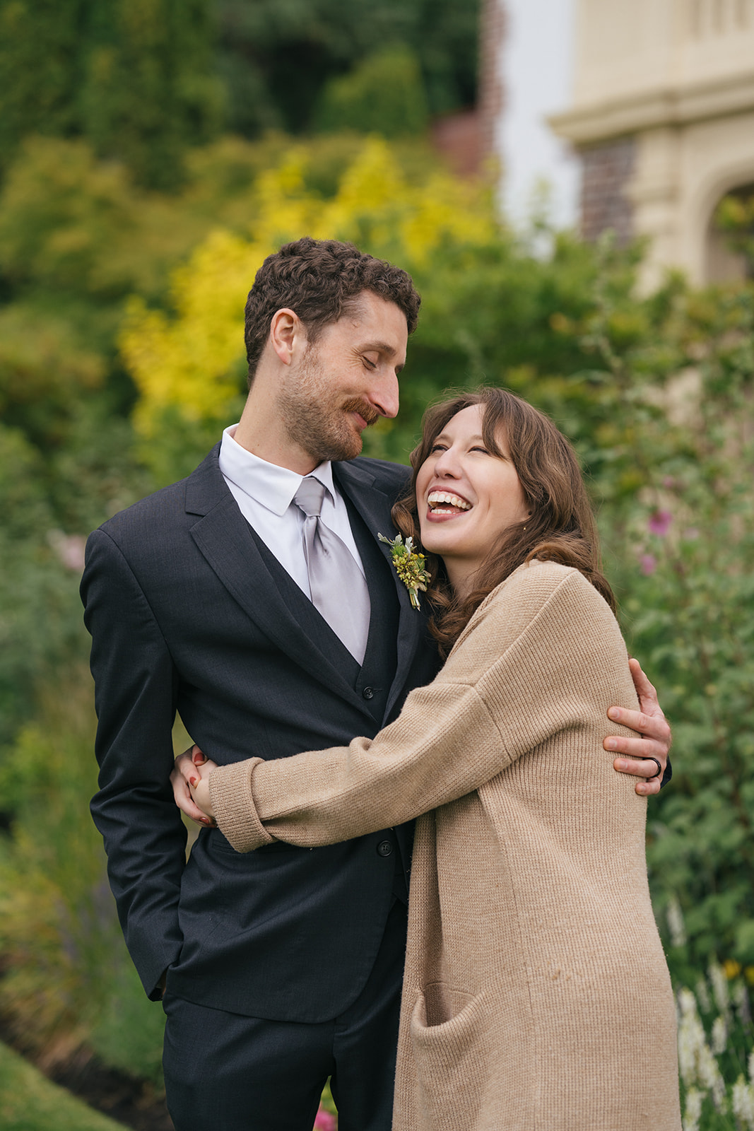 Couple embracing and laughing together during cocktail hour portraits
