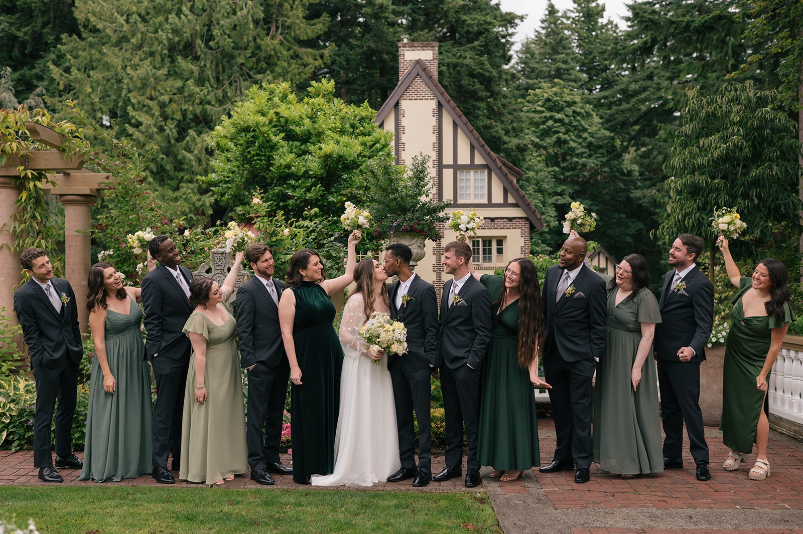 Full wedding party celebrating together in the gardens at Lairmont Manor.