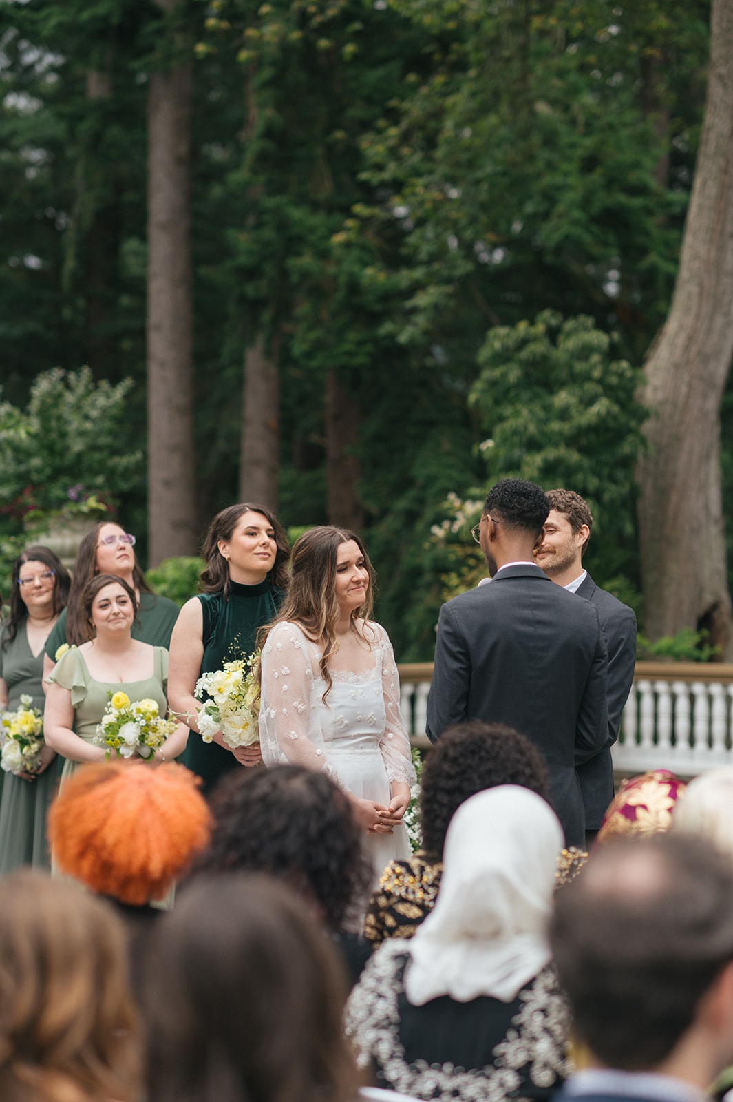 Couple standing together at altar surrounded by wedding party during Lairmont Manor ceremony