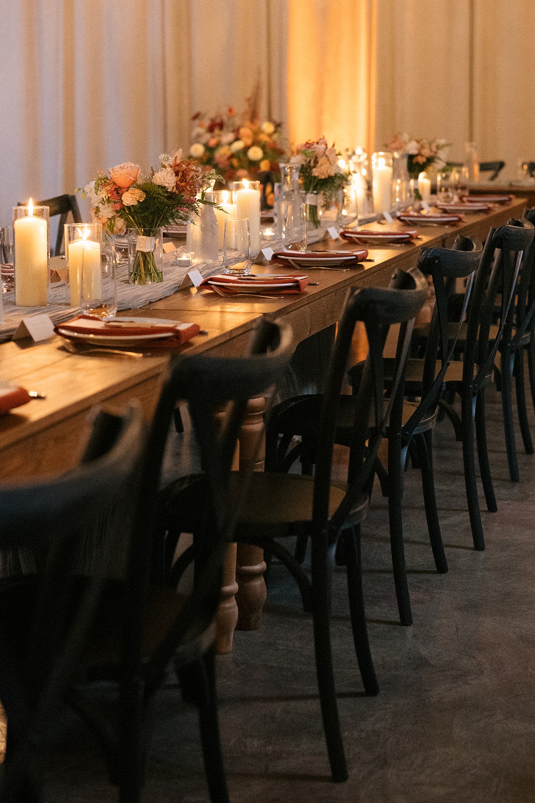 Wedding reception space glowing with candlelight at Hideaway Cellars